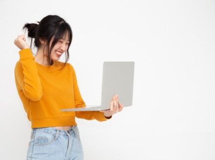 Premium Photo _ Young asian woman in yellow casual clothes holding laptop